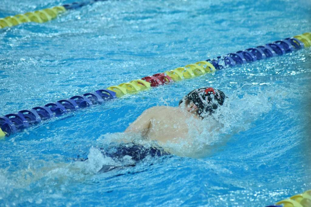 Kenais Koda Poulin competes in the state swimming finals at Bartlett High School in Anchorage on Saturday, Nov. 6, 2021. (Camille Botello/Peninsula Clarion)