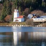 Lighthouse Village is reflected in an extreme high tide in the Mariner Park lagoon on Friday afternoon, Nov. 5, 2021, in Homer, Alaska. (Photo by Michael Armstrong/Homer News)