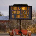A reader board sign on the Sterling Highway announces COVID-19 testing and vaccines at the South