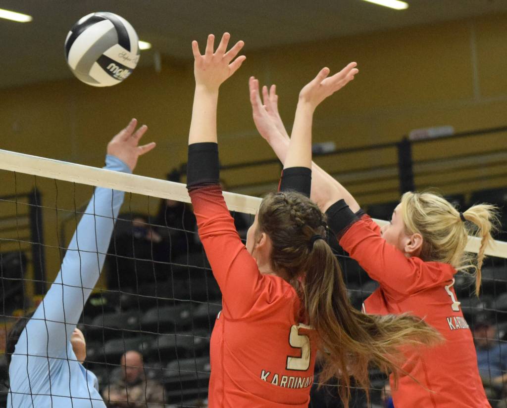 Valdez hitter Momoe Togaage attacks against Kenai blockers Brooke Ashley and Calani Holmes during the 3A state volleyball championship game at the Alaska Airlines Center in Anchorage, Alaska, on Saturday, Nov. 13, 2021. (Camille Botello/Peninsula Clarion)