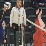 Homers Gracie Gummer goes up for a kill against Kenai blockers Calani Holmes and Emma Beck during the 3A state volleyball consolation game at the Alaska Airlines Center in Anchorage, Alaska, on Saturday, Nov. 13, 2021. (Camille Botello/Peninsula Clarion)