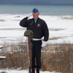 Eric Henley salutes the Fallen Soldier Battlefield Cross during the Veterans Day ceremony at the Alaska Islands and Ocean Visitor Center on Thursday, Nov. 11. (Photo by Sarah Knapp/Homer News)