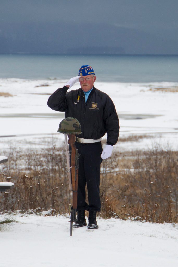 Eric Henley salutes the Fallen Soldier Battlefield Cross during the Veterans Day ceremony at the Alaska Islands and Ocean Visitor Center on Thursday, Nov. 11. (Photo by Sarah Knapp/Homer News)
