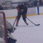 West Anchorage High School's Marty Tumey lines up the puck to score against Kenai during the End of the Road Tourney in Homer Friday, Nov. 18. (Photo by Sarah Knapp/Homer News)