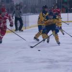 Mariner's Micah Williamson steals the puck from the Warrior's Karson McGrew as he advances down the rink. (Photo by Sarah Knapp/Homer News)