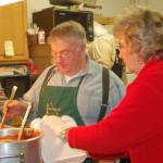 File photo by Michael Armstrong / Homer News
Ben Mitchell, left, serves spaghetti to helper Pat Wells in the kitchen at a past Share the Spirit spaghetti feed.