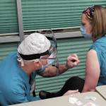 Family practice physician Christina Tuomi, D.O., (right) gets Homer's first dose of Pfizer's COVID-19 vaccine from Emergency Department nurse Steve Hughes (left) on Thursday, Dec. 17, 2020 at South Peninsula Hospital in Homer, Alaska. Tuomi has been the hospital's medical lead throughout the pandemic. (Photo courtesy Derotha Ferraro/South Peninsula Hospital)