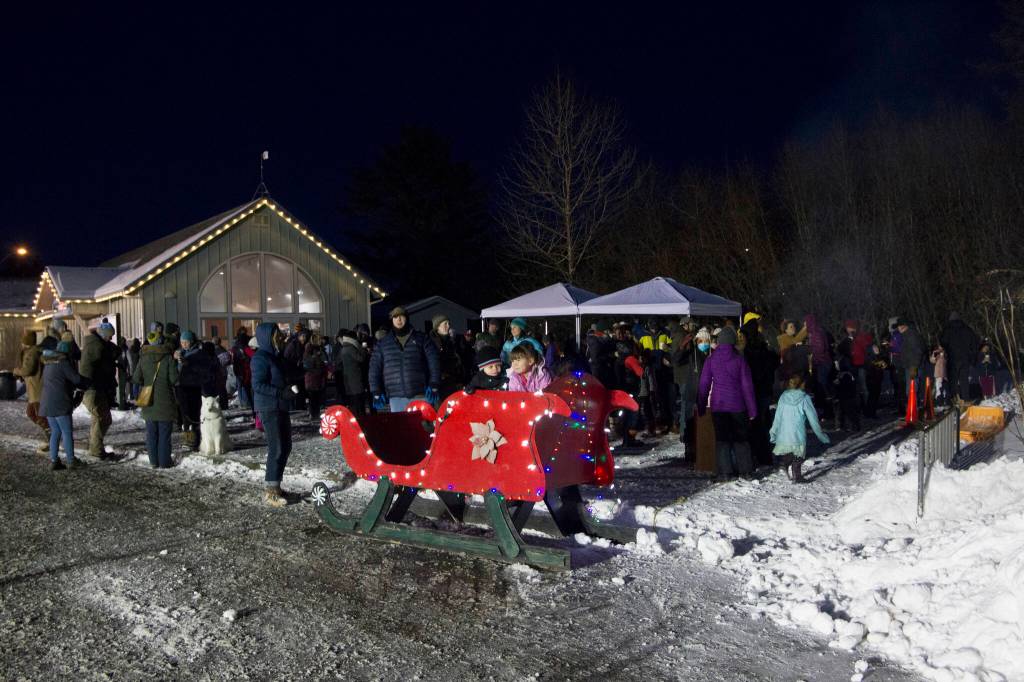 Dozens of community members gathered at the Homer Chamber of Commerce Visitors Center to enjoy the holiday tree lighting, Christmas carols, hot chocolate and Santa Claus. (Photo by Sarah Knapp/Homer News)