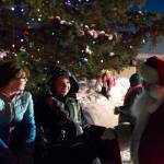 Santa Claus listens as children tell him their wishes for Christmas during the Homer Chamber of Commerce holiday tree lighting event. (Photo by Sarah Knapp/Homer News)