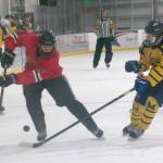 Brandonn Campbell of Juneau-Douglas keeps the puck from Dylan Arno of Homer on Friday, Dec. 3, 2021, at Kevin Bell Arena in Homer, Alaska. (Photo by Sarah Knapp/Homer News)
