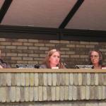 Kenai City Council members James Baisden (left) and Deborah Sounart (right) listen as member Teea Winger (center) speaks in support of legislation opposing government COVID-19 mandates, during a meeting of the Kenai City Council last Wednesday, in Kenai.
