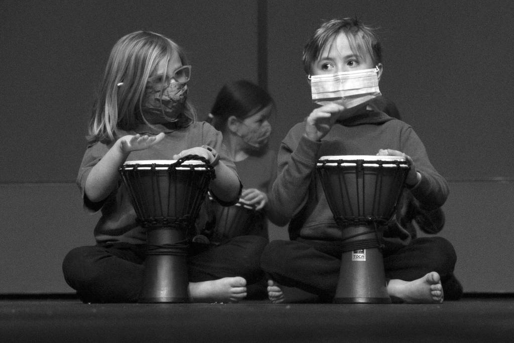 Photo by Sarah Knapp/Homer News 
Two first graders drum along with Sankofa Dance Theater Alaska during their end of residency performance.