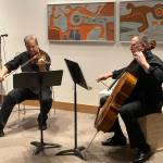 Odin Rathnam and Mannfried Funk performed a variety of arrangements that made many members of the audience smile, cry and even laugh during the Pratt Museum & Parks Glacier Salon benefit on Friday, Dec. 10. Rathnam and Funk performed in the Ron Senungetuk: A Retrospective exhibit. (Photo by Sarah Knapp/Homer News)