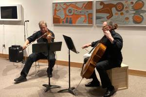 Odin Rathnam and Mannfried Funk performed a variety of arrangements that made many members of the audience smile, cry and even laugh during the Pratt Museum & Parks Glacier Salon benefit on Friday, Dec. 10. Rathnam and Funk performed in the Ron Senungetuk: A Retrospective exhibit. (Photo by Sarah Knapp/Homer News)
