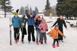 From left to right, Reid Rauch, Ellis Lorentz, Sawyer Johnson, Wylder Johnson, Selma Johnson, Renn Lorentz and Che Lorentz celebrate at the Ski Your Age event held Dec. 26, 2020 at the Lookout Mountain Trails near Homer, Alaska. (Photo by Lila Johnson)