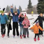 From left to right, Reid Rauch, Ellis Lorentz, Sawyer Johnson, Wylder Johnson, Selma Johnson, Renn Lorentz and Che Lorentz celebrate at the Ski Your Age event held Dec. 26, 2020 at the Lookout Mountain Trails near Homer, Alaska. (Photo by Lila Johnson)