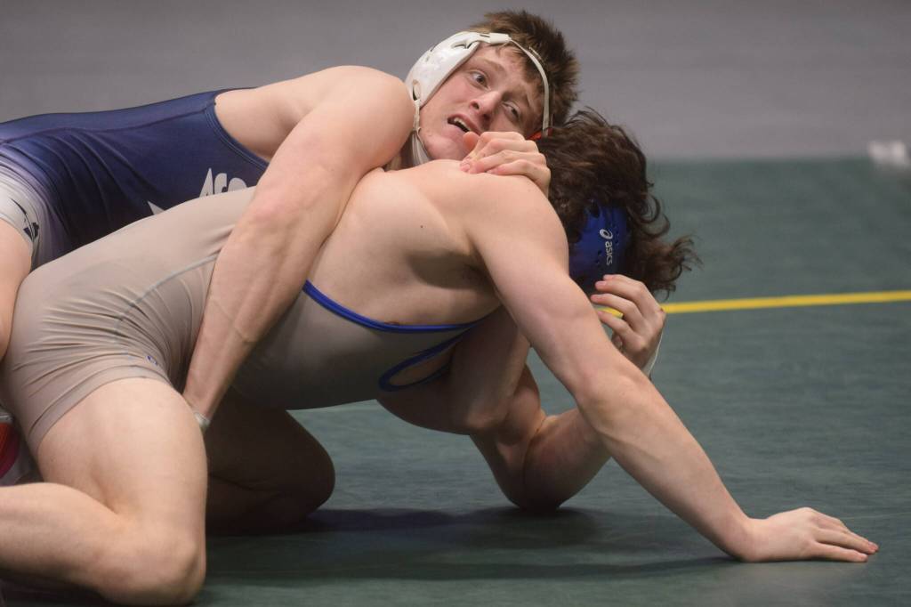 Soldotna High Schools Wayne Mellon wins a DI wrestling title during the state tournament at the Alaska Airlines Center in Anchorage on Saturday, Dec. 18, 2021. (Camille Botello/Peninsula Clarion)