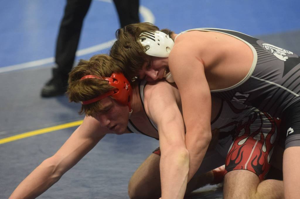 Nikiskis Simon Grenier wins a title in the Division II state wrestling championship at the Alaska Airlines Center in Anchorage on Saturday, Dec. 18, 2021. (Camille Botello/Peninsula Clarion)