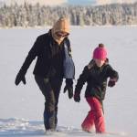 Lisa Dehlbom and her granddaughter, Drew Slegers, snowshoe on Headquarters Lake near Soldotna, Alaska, on Tuesday, Dec. 21, 2021. (Photo by Jeff Helminiak/Peninsula Clarion)