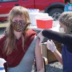 South Peninsula Hospital registered nurse Anne Garay gives Jessica Entsminger her second COVID-19 vaccine on Friday, May 7, 2021, at a pop-up vaccination clinic at the Boathouse Pavillion on the Homer Spit in Homer, Alaska. About 25 people received vaccines in the first 3.5 hours of the 4-hour clinic. (Photo by Michael Armstrong/Homer News)