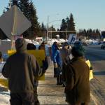 Protesters of the Jan. 6 U.S. Capitol insurrection waves signs toward oncoming traffic at WKFL Park on Thursday, Jan. 6, promoting the right to vote and challenging people to protect democracy. (Photo by Sarah Knapp/Homer News)