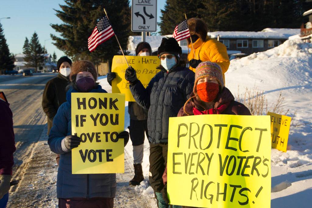 A group of community members gather together on Thursday, Jan. 6 at WKFL Park to protest the insurrection at the U.S. Capitol on the one-year anniversary of the attack. (Photo by Sarah Knapp/Homer News)