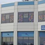 At the start of the COVID-19 pandemic in March of 2020, signs in the windows of the Long Term Care wing at South Peninsula Hospital in Homer, Alaska, say All is well. (Photo by Michael Armstrong/Homer News)