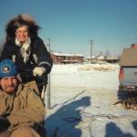 Michael Armstrong, seated, in sled, gives his mother, Sylvia Jander, the unique Alaska experience of driving a sled-dog team in February 1989 in Anchorage, Alaska. (Photo by Jenny Stroyeck)