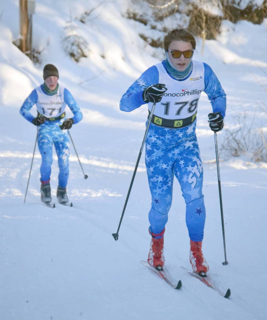 Soldotna High Schools Quinten Cox leads teammate Benn Abel up the Raven loop during an interval classic race Sunday, Jan. 16, 2022, at Besh Cup 4 at Tsalteshi Trails just outside of Soldotna, Alaska. (Photo by Jeff Helminiak/Peninsula Clarion)