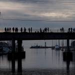 People watch waters rise in Santa Cruz harbor in Santa Cruz, Calif., Saturday, Jan. 15, 2022.  An undersea volcano has erupted in spectacular fashion near the Pacific nation of Tonga on Saturday.  Following the eruption, a tsunami advisory was issued for Hawaii, Alaska and the U.S. Pacific coast.(AP Photo/Nic Coury)