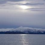 Clouds obscure the sun on Monday, Jan. 18, 2022, as seen from the Mariner Park beach in Homer, Alaska. Yukon Island is in the distance. Almost a month after the winter solstice, the sun rises higher in the sky at mid-day. (Photo by Michael Armstrong/Homer News)