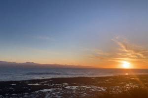 The sun sets over Kachemak Bay as seen from Ocean Drive Loop on Tuesday, Jan. 25. (Photo by Sarah Knapp/Homer News)