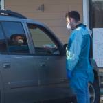 A COVID-19 test administrator discusses the testing process with a patient during the popup rapid testing clinic at Homer Public Health Center on Tuesday, Jan. 25, 2022, in Homer, Alaska. (Photo by Sarah Knapp/Homer News)