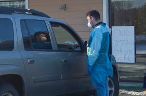 A COVID-19 test administrator discusses the testing process with a patient during the popup rapid testing clinic at Homer Public Health Center on Tuesday, Jan. 25, 2022, in Homer, Alaska. (Photo by Sarah Knapp/Homer News)