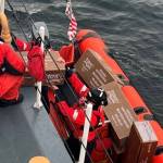 Courtesy photo / USCG
Petty Officer 2nd Class Roy Jamison hands boxes of donated goods down to Lt. J.g. Matthew Hall as they prepare to ferry them to Wrangell harbor via the Coast Guard Cutter Anacapas small boat.