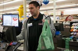 Brian Lauth, closing manager for Super Bear Supermarket IGA, bags groceries Thursday, Feb. 13, 2020. Next month, the Finance Committee for the City and Borough of Juneau will consider whether to exempt grocery purchases from the city's sales tax. (Ben Hohenstatt/Juneau Empire File)