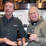 Geoff and Marcy Larson show off a special beer being brewed to celebrate the brewerys 35th anniversary on Feb. 4. (Dana Zigmund / Juneau Empire)