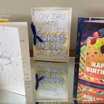 Birthday cards celebrating Toras Fisks 100th birthday, including a homemade one by his brother, fill all of the available counter space in his home. (Photo by Sarah Knapp/Homer News)