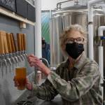 Grace Ridge Brewing co-owner Sherry Stead draws a pint at the brewerys reopening last Friday, Feb. 11, 2022, at the new location on Smoky Bay Way in Homer, Alaska. (Photo by Michael Armstrong/Homer News)