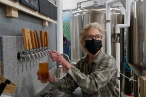 Grace Ridge Brewing co-owner Sherry Stead draws a pint at the brewerys reopening last Friday, Feb. 11, 2022, at the new location on Smoky Bay Way in Homer, Alaska. (Photo by Michael Armstrong/Homer News)