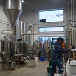 Grace Ridge Brewing co-owner Don Stead checks the brew tanks for the brewerys reopening last Friday, Feb. 11, 2022, at the new location on Smoky Bay Way in Homer, Alaska. (Photo by Michael Armstrong/Homer News)