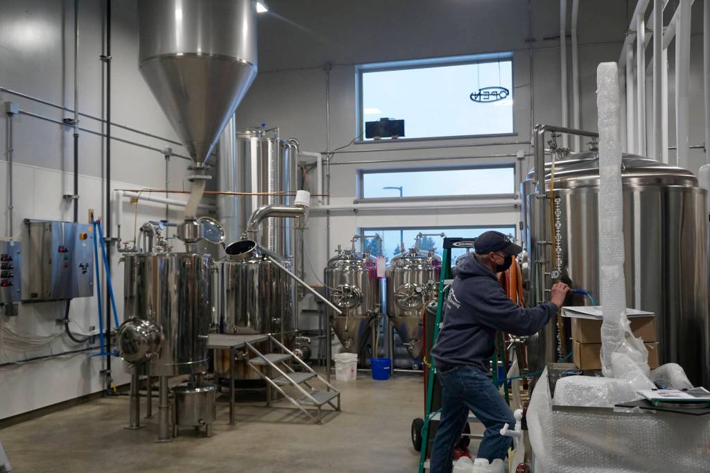 Grace Ridge Brewing co-owner Don Stead checks the brew tanks for the brewerys reopening last Friday, Feb. 11, 2022, at the new location on Smoky Bay Way in Homer, Alaska. (Photo by Michael Armstrong/Homer News)