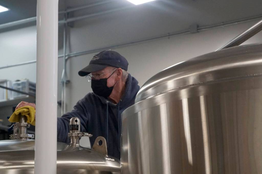 Grace Ridge Brewing co-owner Don Stead checks the brew tanks for the brewerys reopening last Friday, Feb. 11, 2022, at the new location on Smoky Bay Way in Homer, Alaska. (Photo by Michael Armstrong/Homer News)