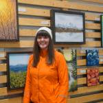 Artist Jen Depesa stands by her art work at the reopening of Grace Ridge Brewing last Friday, Feb. 11, 2022, at the new location on Smoky Bay Way in Homer, Alaska. Grace Ridge will continue to show art work in its tasting room at the brewery. (Photo by Michael Armstrong/Homer News)