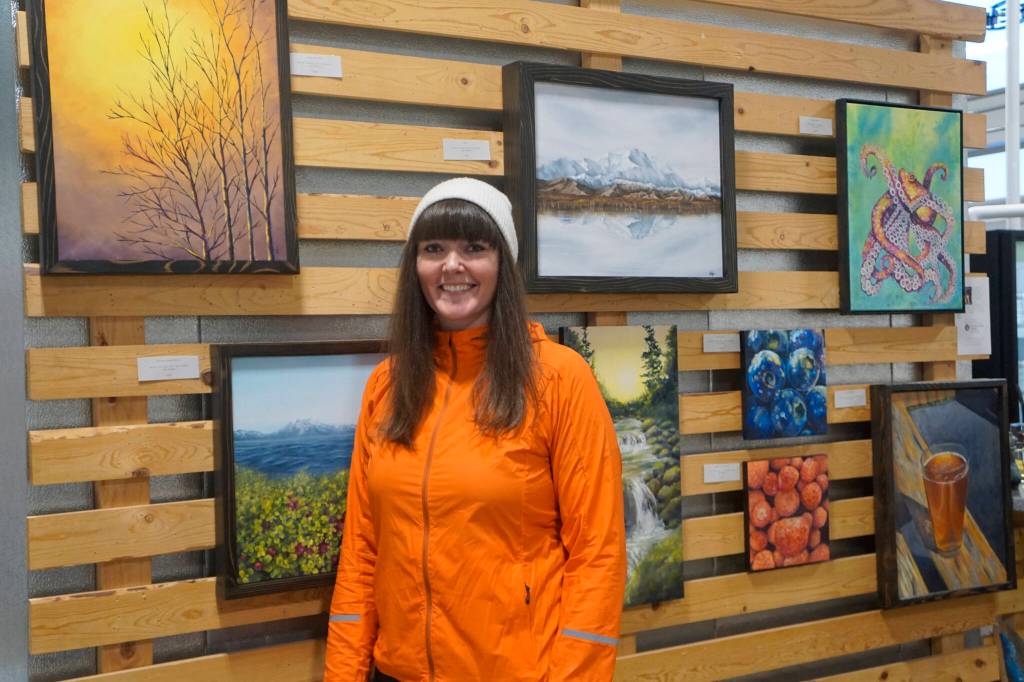 Artist Jen Depesa stands by her art work at the reopening of Grace Ridge Brewing last Friday, Feb. 11, 2022, at the new location on Smoky Bay Way in Homer, Alaska. Grace Ridge will continue to show art work in its tasting room at the brewery. (Photo by Michael Armstrong/Homer News)