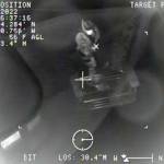 A Coast Guard rescue swimmer pulls in a rescue basket during an emergency call to a stricken vessel south of Sitka on Feb. 7, 2022. (Screenshot)