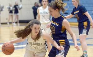 Soldotnas Tanner Inman looks to drive on Homers Mel Morris on Thursday, Feb. 17, 2022, at Soldotna High School in Soldotna, Alaska. (Photo by Camille Botello/Peninsula Clarion)