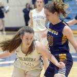 Soldotna's Tanner Inman looks to drive on Homer's Mel Morris on Thursday, Feb. 17, 2022, at Soldotna High School in Soldotna, Alaska. (Photo by Camille Botello/Peninsula Clarion)