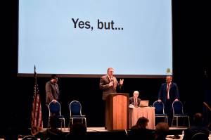 Gov. Mike Dunleavy speaks to the Alaska Municipal League and Alaska Conference of Mayors winter meeting at Centennial Hall on Thursday, Feb. 17, 2022. The governor gave a presentation on the state finances which included a slide referencing the disagreements with his proposals some lawmakers were likely to have. (Peter Segall / Juneau Empire)