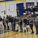 Lady Mariner seniors line up with their parents at the Homer vs. Nikiski basketball game on Friday, Feb. 25, 2002, in the Alice Witte Gym at Homer High School, Homer, Alaska. From lft to right are Steve Glasman, Olivia Glasman (player) and Claudia Haines; Derotha Ferraro, Delilah Harris (player) and Gary Harris; Jeff Erickson, Sophie Ellison (Player) and Shari Ellison; Jamin Morris, Melanie Morris (player) and Cate Morris; and Elton Anderson, Kaylin Anderson (player) and Monica Anderson. (Photo by Michael Armstrong/Homer News)